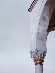 Gold on a light marble pillar in mosque
