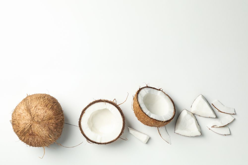 Flat lay with coconut on plain background, top view
