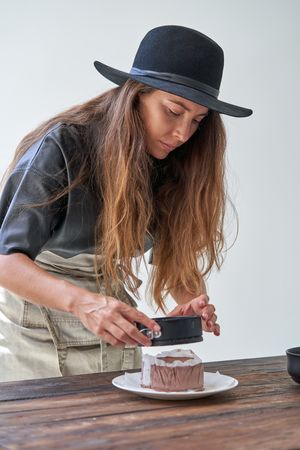Young woman serving chocolate dessert