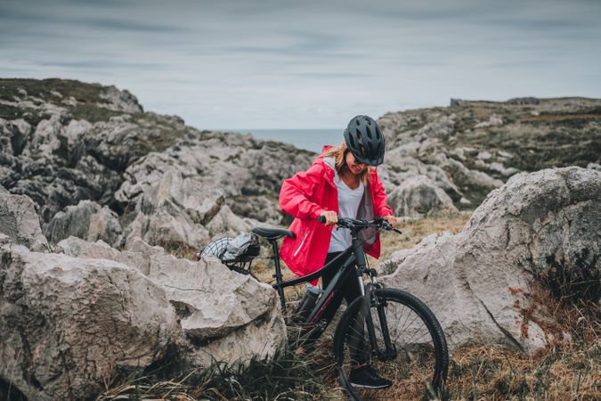 Female bicyclist on rocks