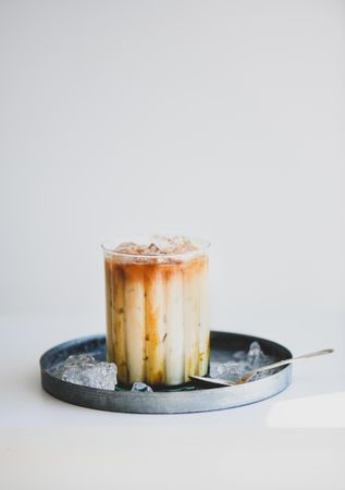 Iced coffee cocktail with tray and spoon