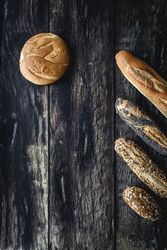 Assorted gold homemade bread on dark wood background
