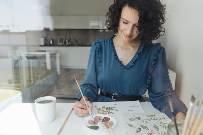 Woman painter working at home