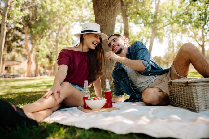 Cheerful young couple enjoying at picnic