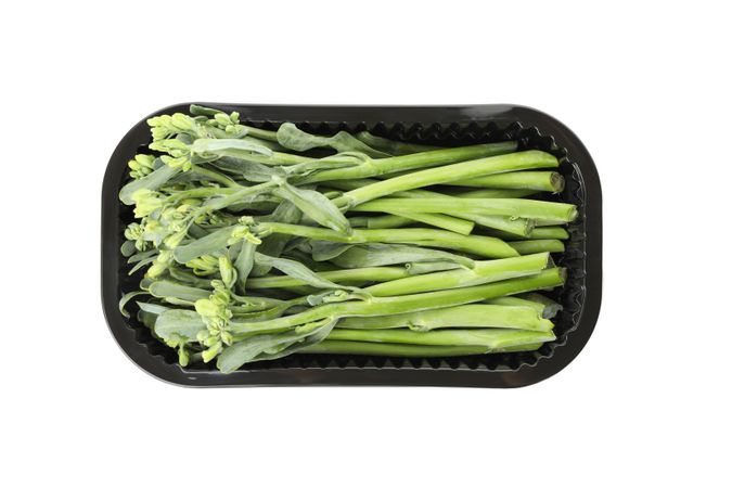 Plastic container with broccolini isolated on plain background