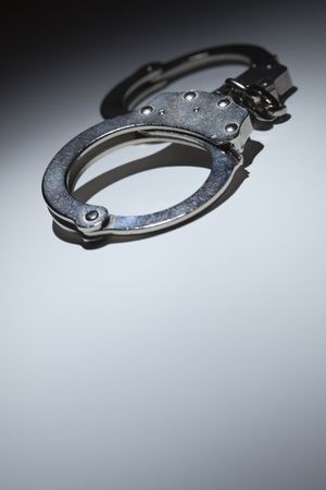Abstract Pair of Handcuffs Under Spot Light - Text Room