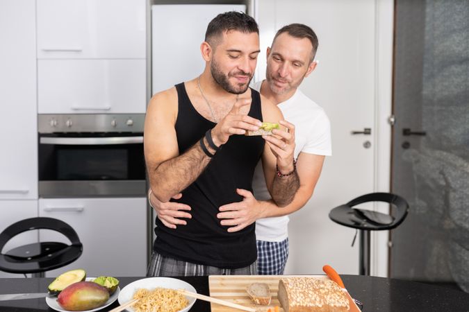 Cute male couple preparing sandwich for a healthy meal