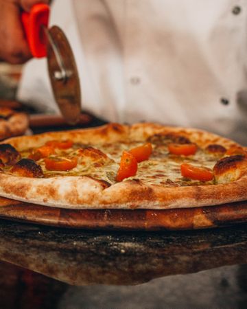 Chef cutting a pizza