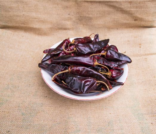 One bowl of Dry Pepper or red chili on the jute fiber fabric