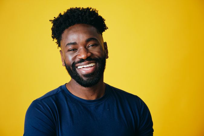 Portrait of joyful Black man on yellow background