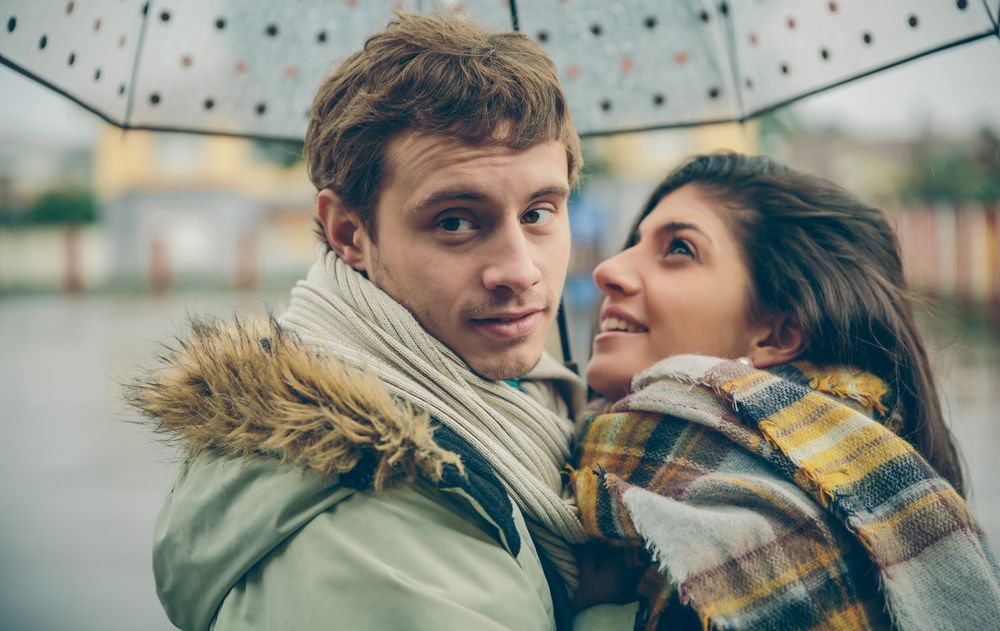 Cute couple under spotted umbrella
