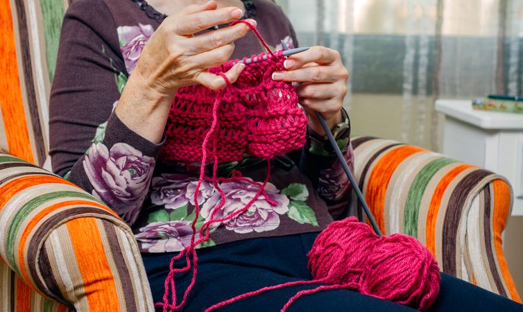 Hands of woman knitting a wool sweater