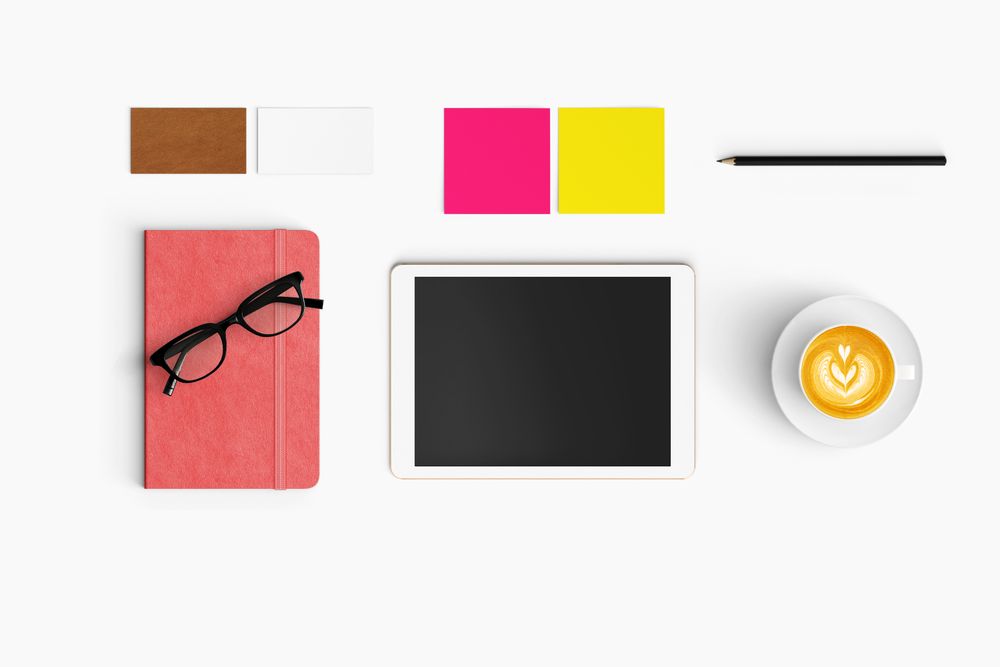Modern workspace with coffee cup, smartphone, paper, notebook and tablet copy space