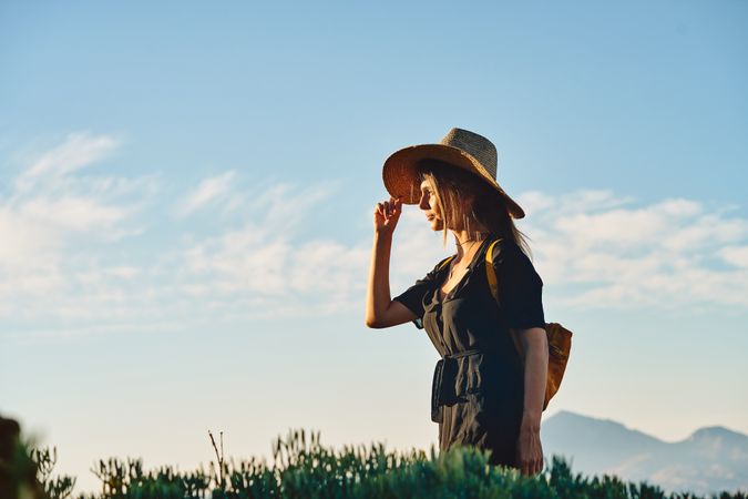 Woman traveler in straw hat walking