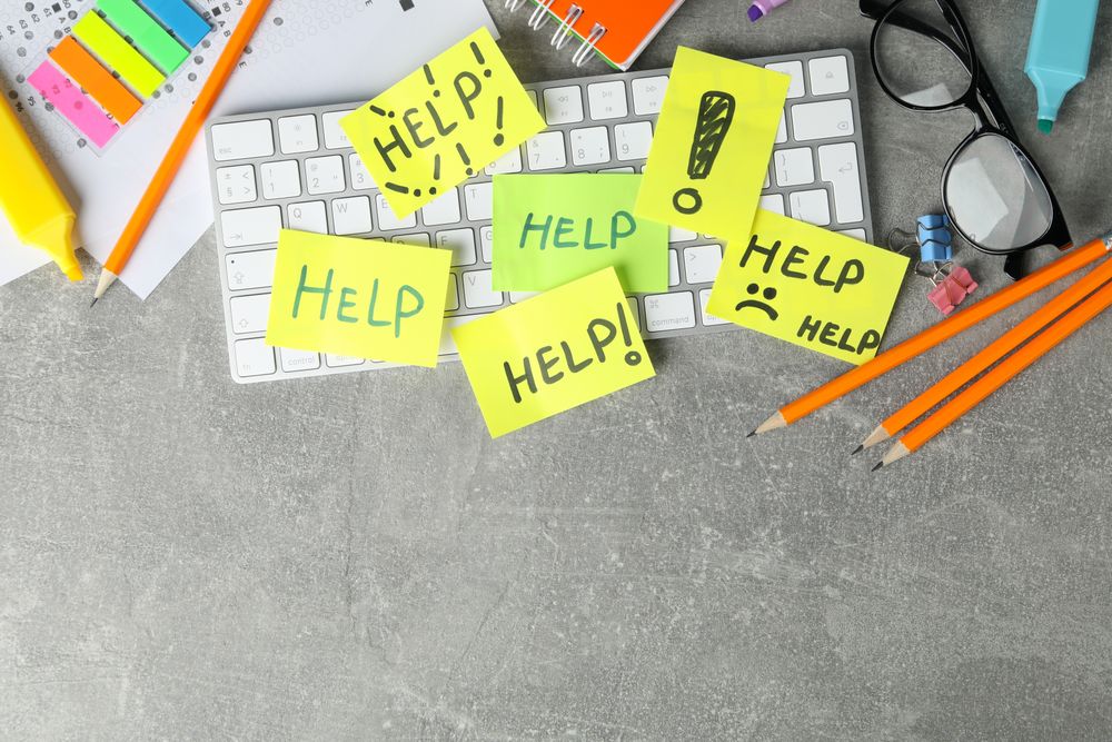Looking down on sticky notes on keyboard with copy space