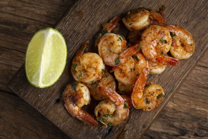 Delicious grilled prawns on wooden background.