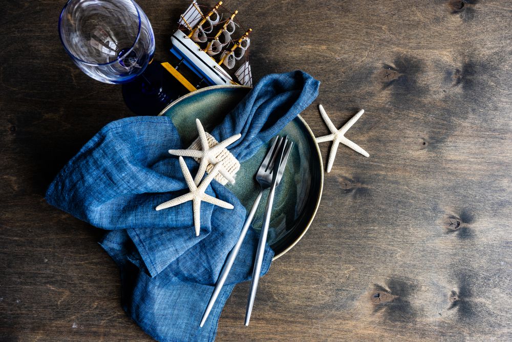 Summer concept with sea stars and shells on wooden table