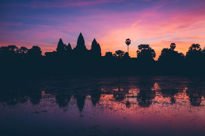 Bright sunset sky over temple and lake