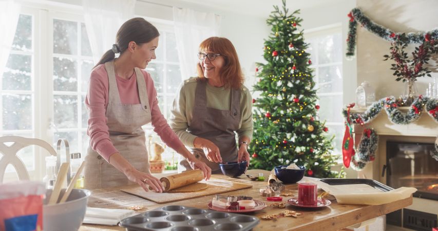 Woman and her Mother Bonding While Cooking, Talking, Spending Time Together on Holidays