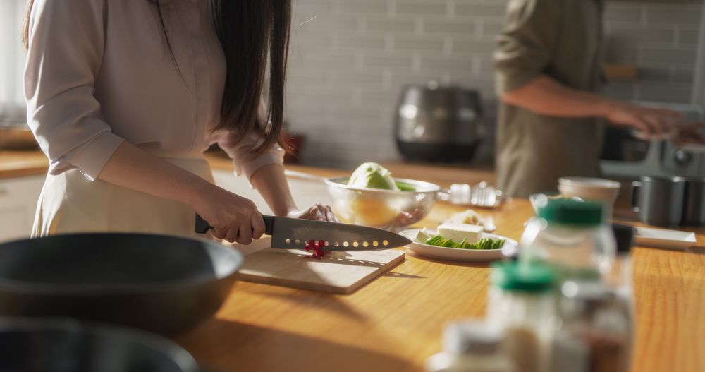 Close Up of a Young Couple Preparing Healthy Vegetarian Food at Home in the Kitchen.