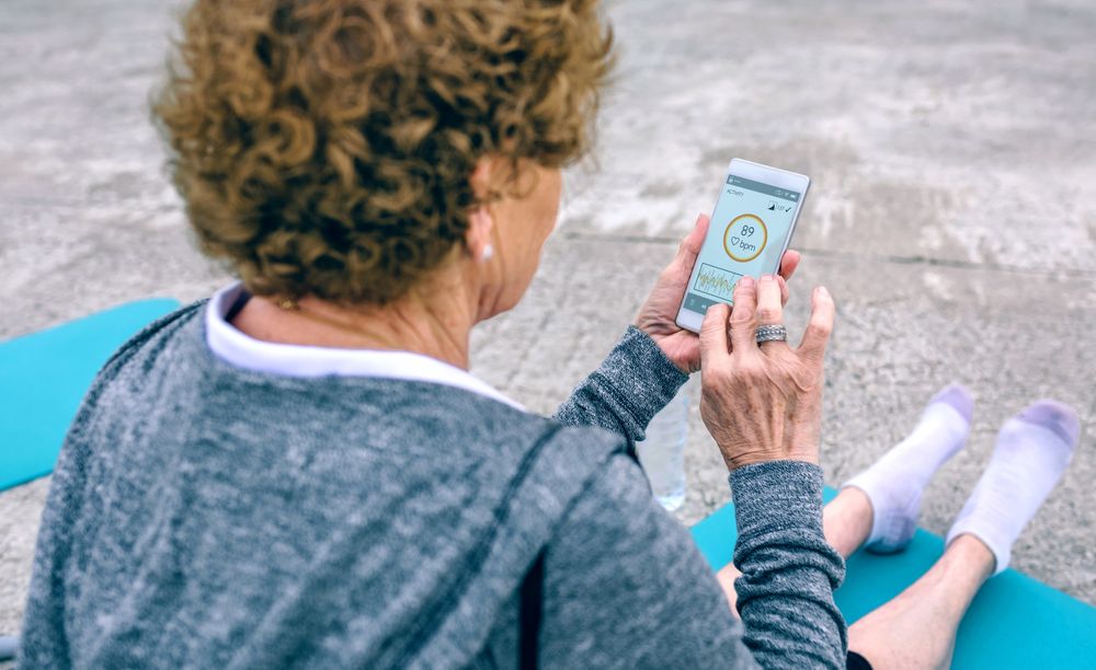 Back view of Mature woman using smartphone