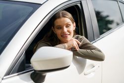 A Cheerful Young Woman Feeling Joy and Happiness While Enjoying a Scenic Drive in Her Car