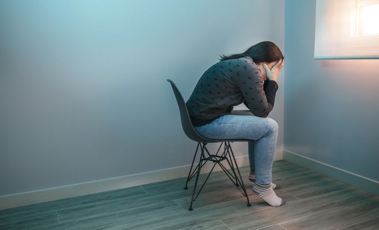 Worried woman sitting on a chair