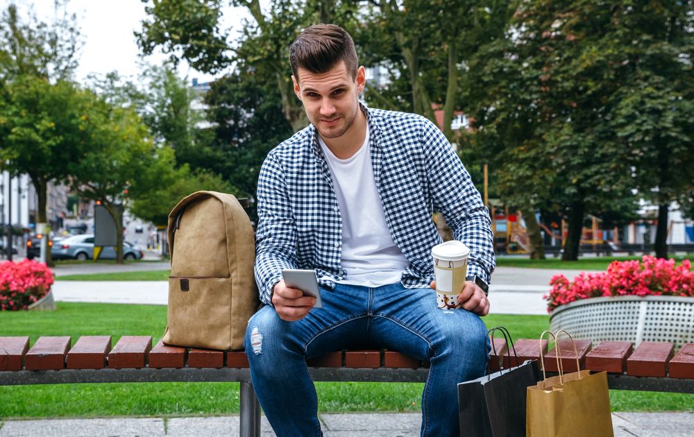 Man with mobile looking camera