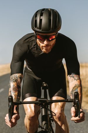 Professional cyclist in black outfit