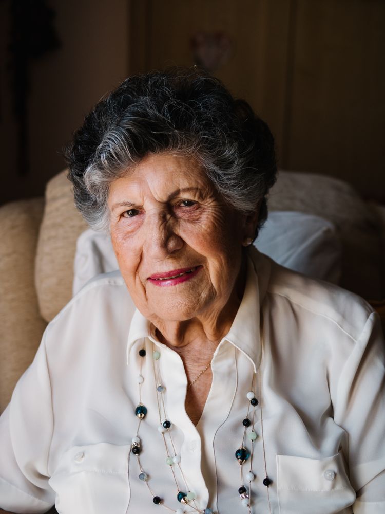 Portrait of mature female in white shirt at home