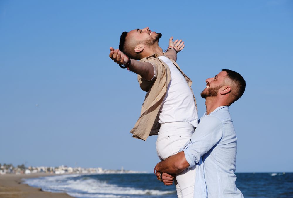 Happy gay couple enjoying and embracing outdoors