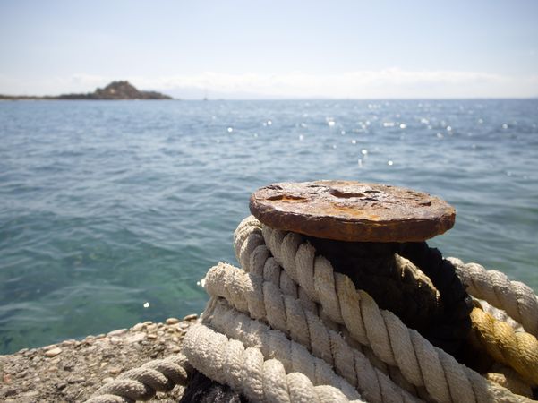 Rusty boat anchor with ropes