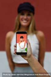 Woman having photo taken on phone 426dRx