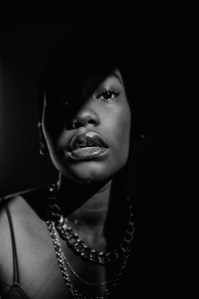 Woman wearing lip-gloss in grayscale