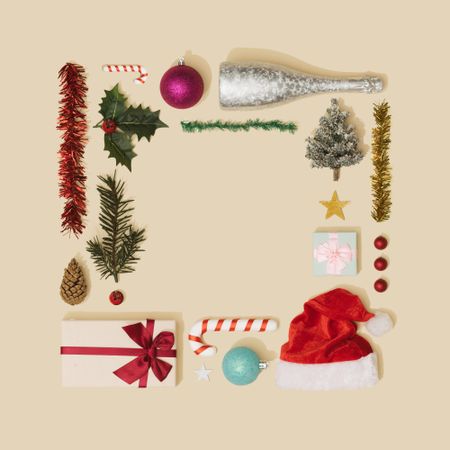 Holiday decorations arranged in a square on cream paper