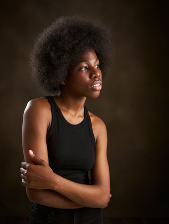 Young Black woman with afro hairstyle seen from the side