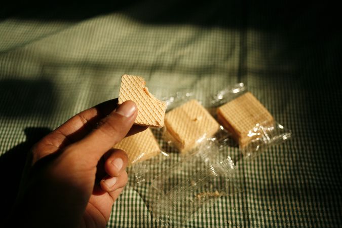 Hand lifting up package of wafers