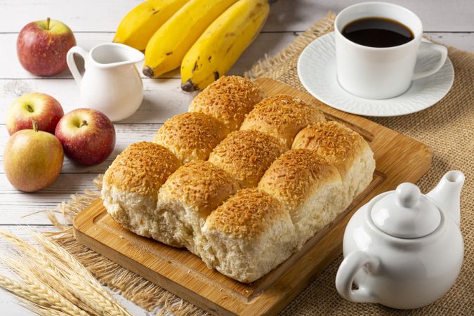 Breakfast table with coconut bread and fruits.