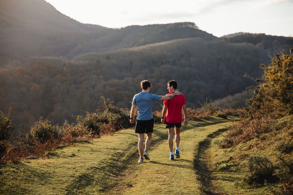 Sportive males taking break after running in mountains