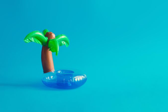 Tropical palm inflatable toy on blue background