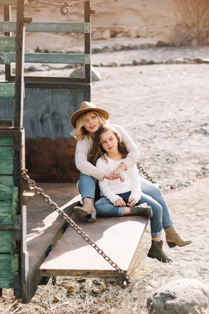 Mother hugging girl in truck body