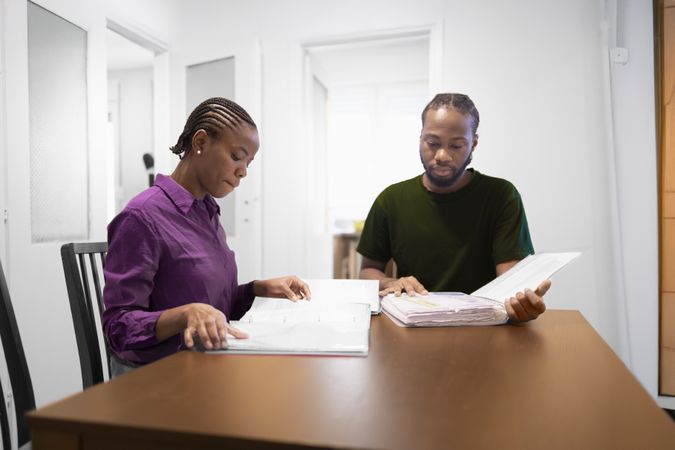 Casual Study Session at Home with Books and Conversation.