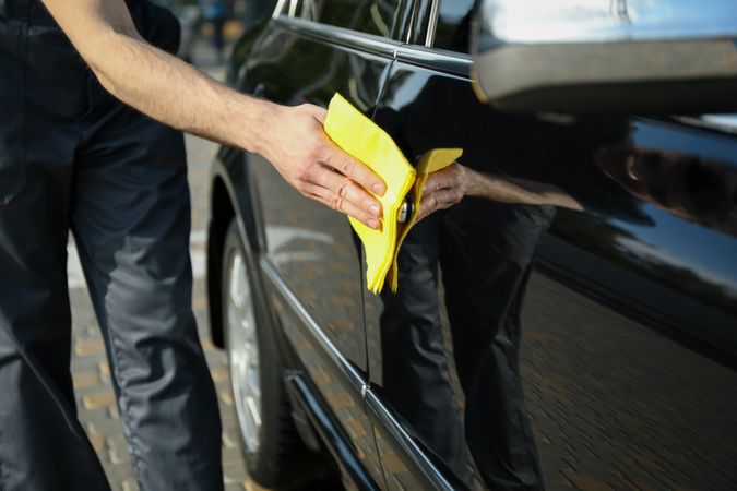 A man rubs a car. Car wash. Clear car concept