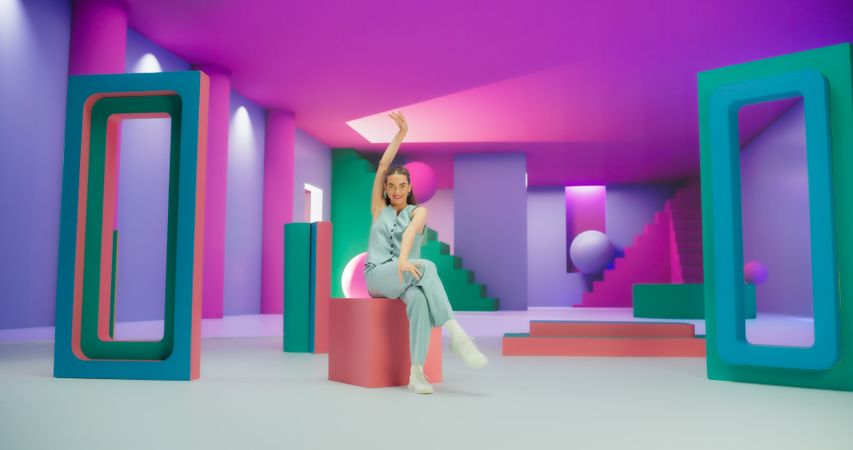 Portrait of Young Woman Sitting in Geometric Abstract Environment, Dancing with Hypnotic Graceful Movements. Fashionable Female Dancer Practicing Her Routine in The Studio