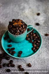 Full teal cup of coffee beans with star anise 5Qlan0
