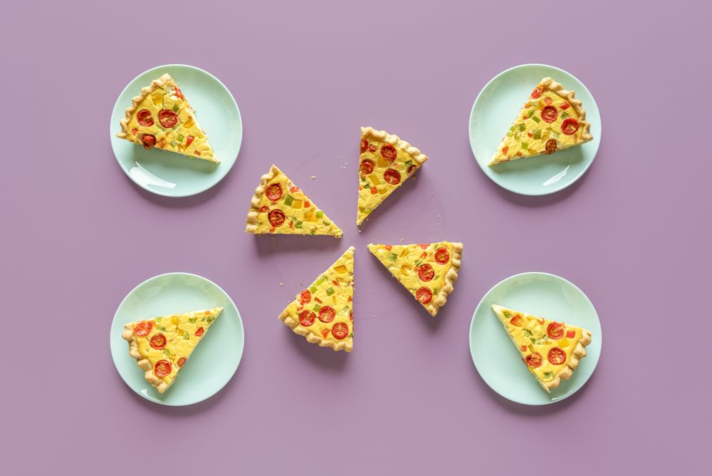 Quiche meal on a purple table, above view