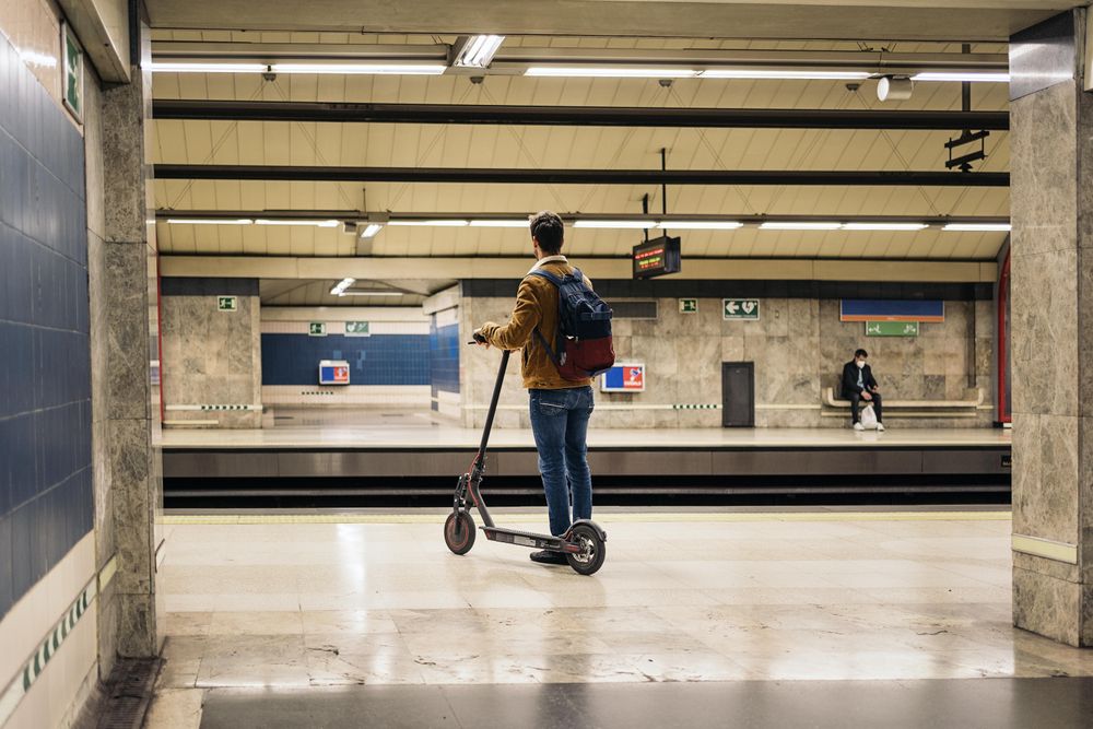 Man riding scooter in subway
