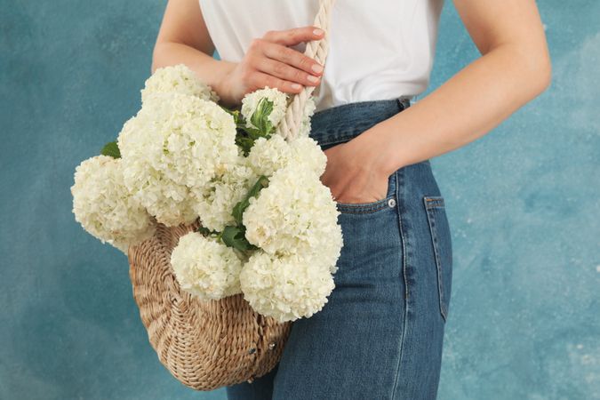 Beautiful fashionable woman with hydrangea flowers. Spring plant