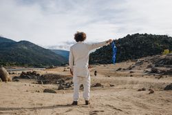 Back of man in jumpsuit waving blue flag