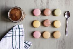 Spoon and napkin near coffee and macaroons